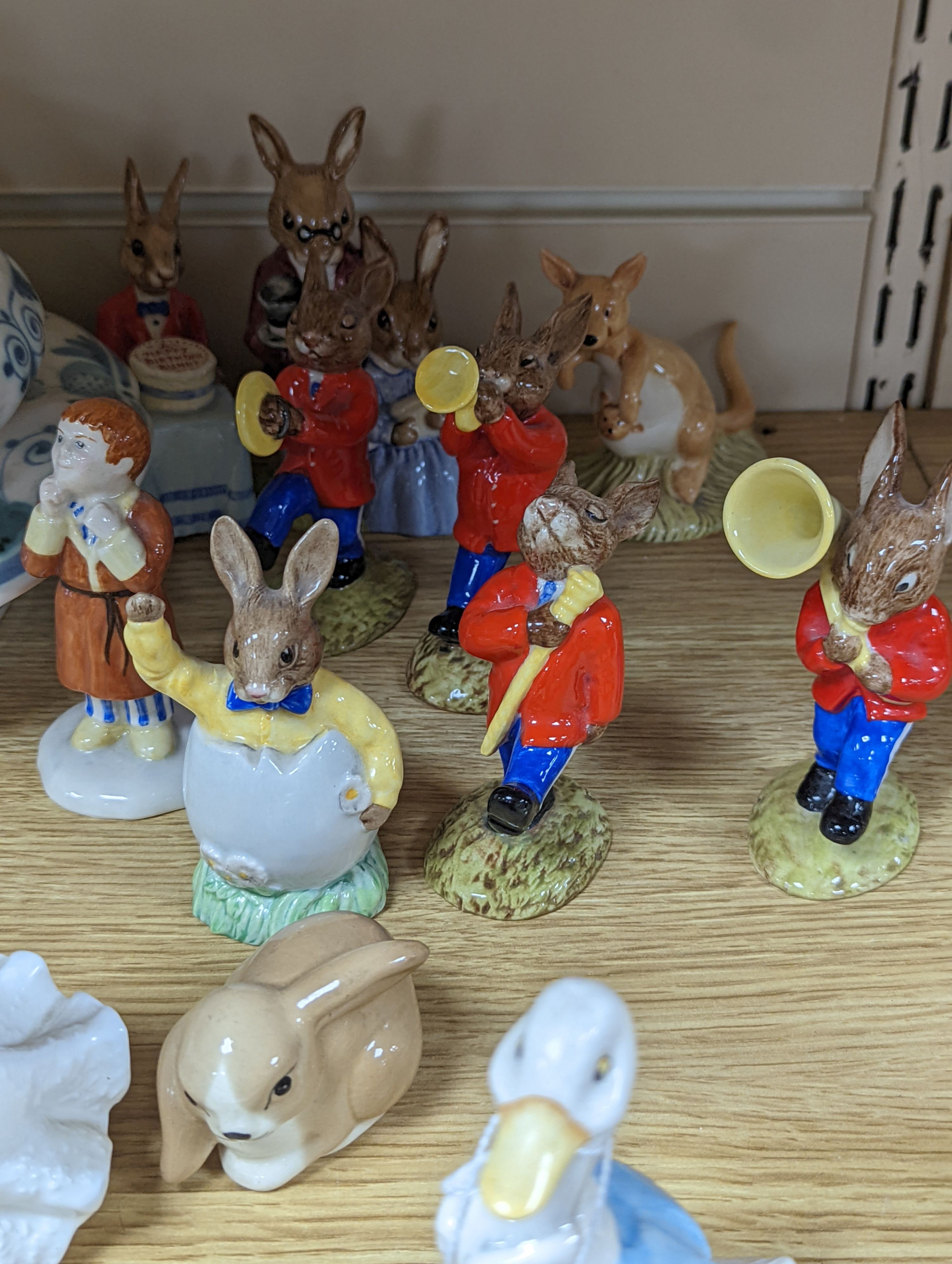 A collection of Royal Doulton figures including Bunnykins, a Doulton vase and other items